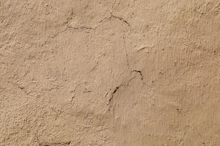 Foto textura da parede de barro e fundo da parede da casa de barro da lama
