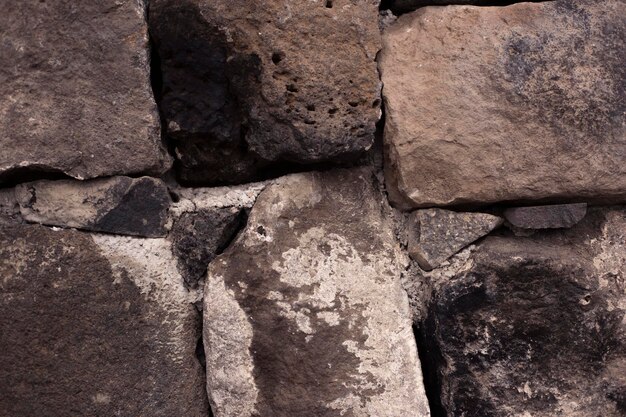 Textura da parede de pedra do antigo castelo Parede de pedra como fundo ou textura