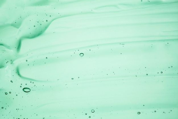 Textura de amostra de óleo de soro cosmético em gel creme transparente com fundo de bolhas