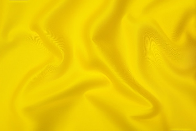 Textura de close-up de tecido laranja ou amarelo natural ou pano da mesma cor. Textura de tecido de algodão natural, seda ou lã, ou material têxtil de linho. Fundo de tela amarela.
