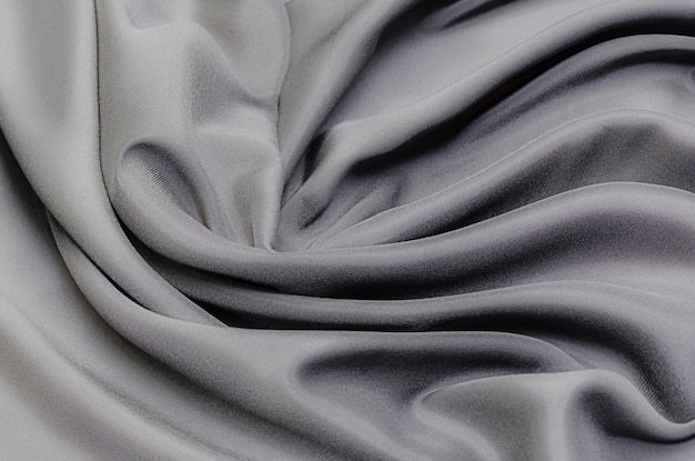 Textura de close-up de tecido natural cinza ou preto ou tecido da mesma cor. Textura de tecido de algodão natural, seda ou lã, ou material têxtil de linho. Fundo de tela preta.