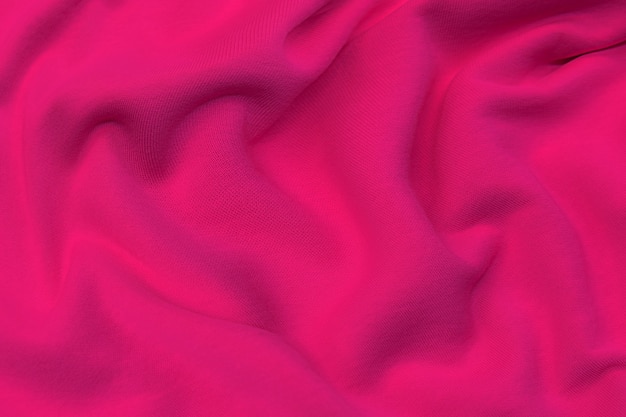 Textura de close-up de tecido vermelho ou rosa natural ou tecido da mesma cor. textura de tecido de algodão natural, seda ou lã, ou material têxtil de linho. fundo de tela vermelho e laranja.