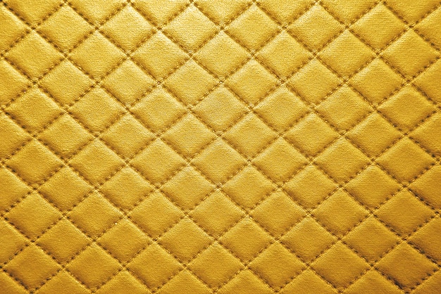 Textura de couro dourado com costura de fundo