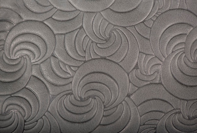 Textura de couro genuíno cinza com padrão de tendência floral em relevo cor fechada para papel de parede ou design de banner Fundo moderno na moda