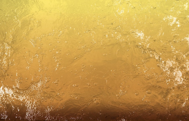 Textura de design de fundo de água dourada manchas de ouro em apresentação colorida amarela ou pano de fundo de parede para banner de site de design gráfico