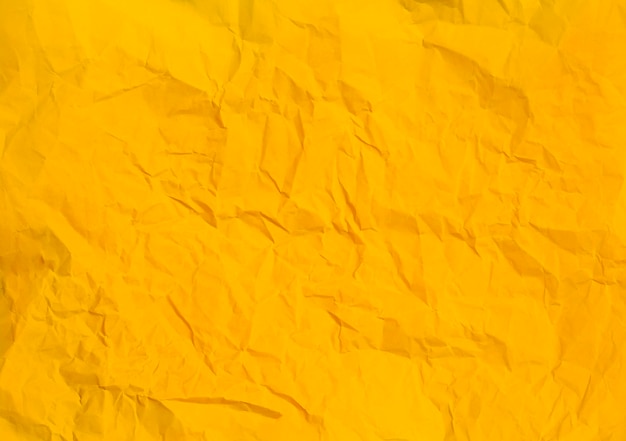 Foto textura de fundo de papel amarelo amassado