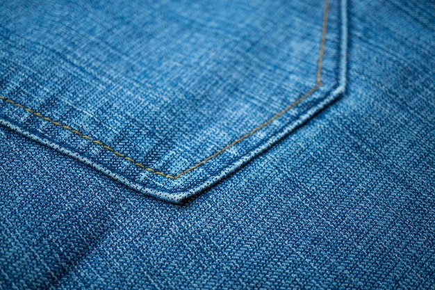 Textura de fundo de tecido jeans azul com detalhes de costura