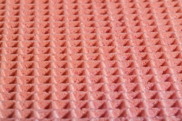 Textura de fundo e a superfície de um waffle de confeitaria na cor rosa