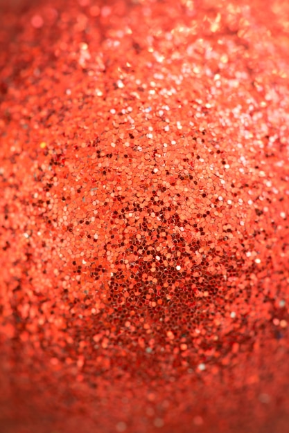 Textura de glitter de uma bola vermelha de Natal