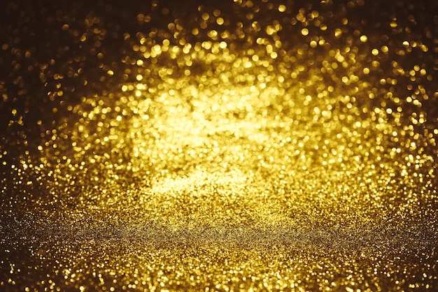 Textura de iluminação de bokeh de glitter dourado Fundo desfocado abstrato para aniversário, aniversário, casamento, véspera de ano novo ou Natal.
