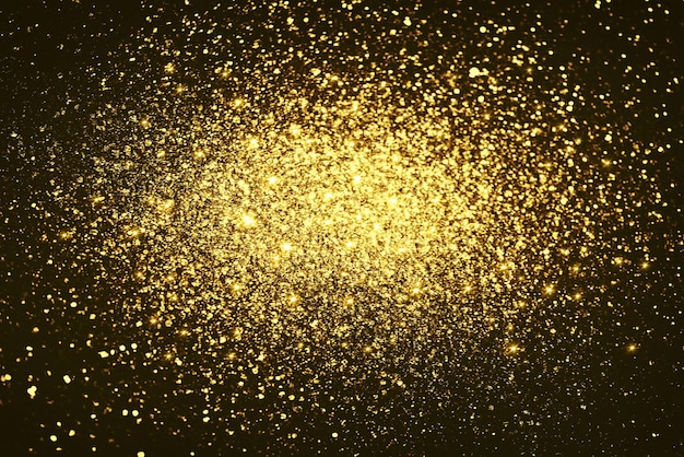 Textura de iluminação de bokeh de glitter dourado fundo desfocado abstrato para aniversário, aniversário, casamento, véspera de ano novo ou natal.