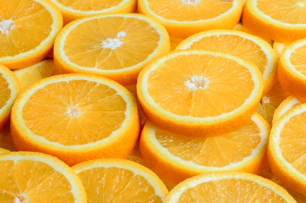 Textura de laranja fatiada, fruta fresca e saudável, que é rica em suco e vitamina c.