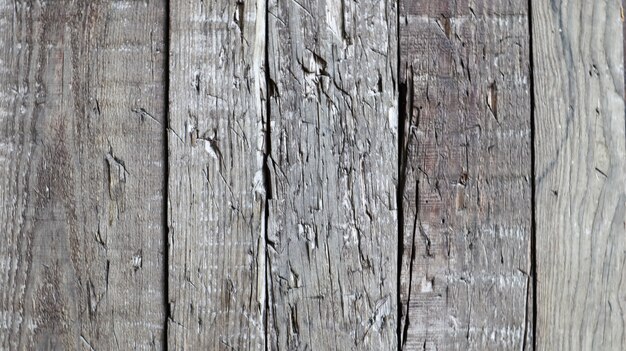 Textura de madeira como pano de fundo. Vista superior da superfície da mesa para fotografar lay-out. Molde abstrato em branco. Galpão de madeira resistida rústico com nós e orifícios para pregos.