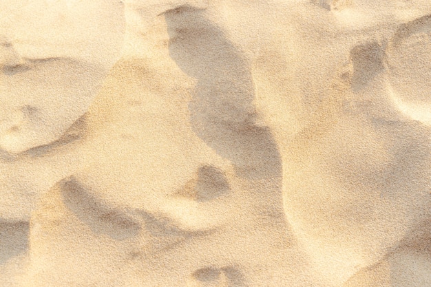 Textura de padrão de areia para o fundo. Padrão de deserto marrom de praia tropical. Fechar-se.