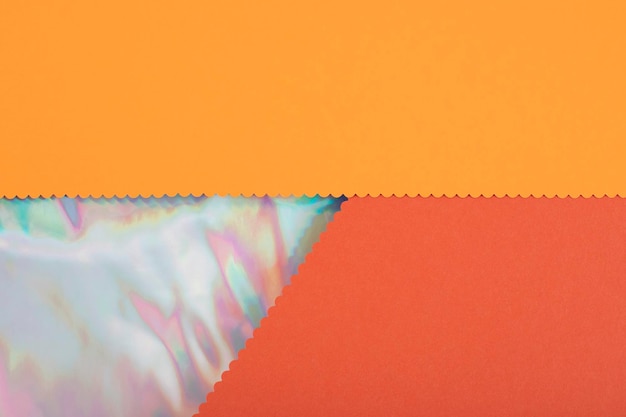 Textura de papel de cor laranja abstrata com inserção de folhas holográficas de cores do arco-íris