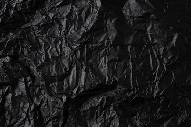 Textura de papel preto amassado.