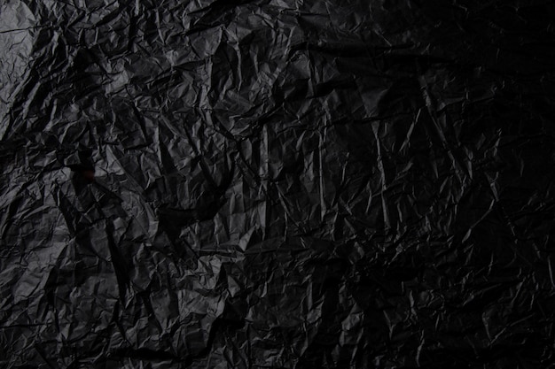 Textura de papel preto amassado.