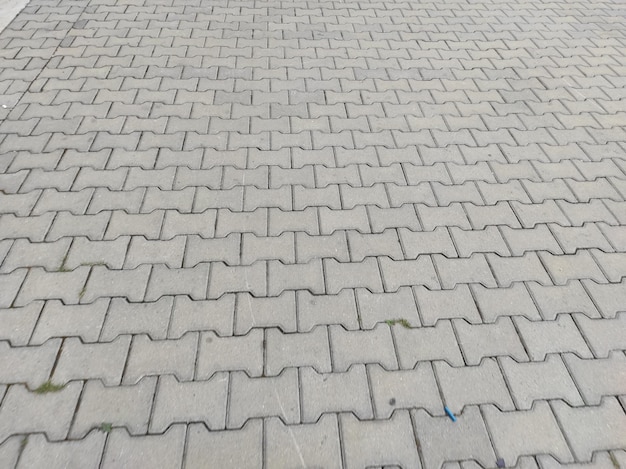 Textura de paralelepípedos Pedras de pavimentação cinzentas fora de close-up Desenho em branco