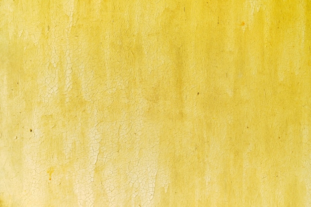 Foto textura de parede de compensado com tinta amarela velha e rachada