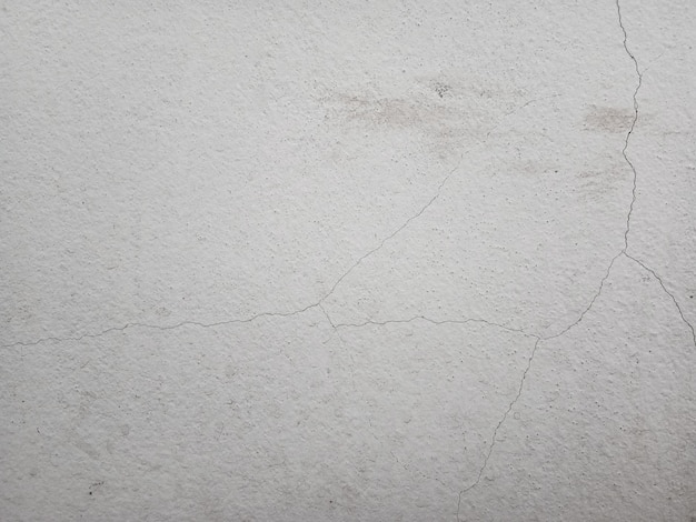 Textura de parede de concreto rachado Fundo de cimento não pintado em estilo vintage para design gráfico ou papel de parede retrô
