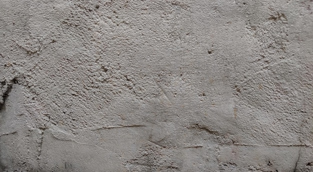 Textura de parede de concreto vazio cinza textura de parede branca rebocada ou parede de rua bagunçada de fundo
