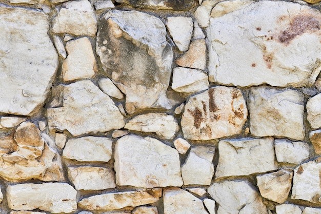 Textura de parede de pedra de alvenaria. Pedras na fundação do antigo castelo. Fundo de parede de pedra para design ou ilustração