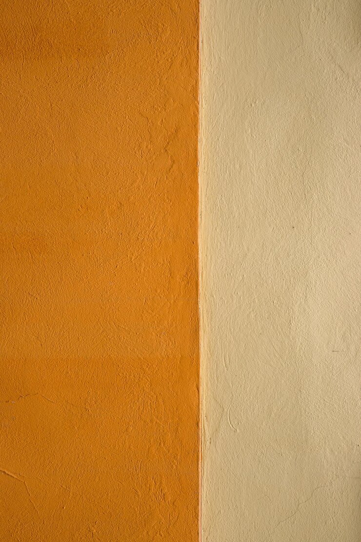 Foto textura de parede laranja vibrante com uma sutil faixa bege perfeita para inspiração de design de fundo ou projeto artístico imagem de imperfeições e detalhes únicos de uma superfície pintada ao ar livre