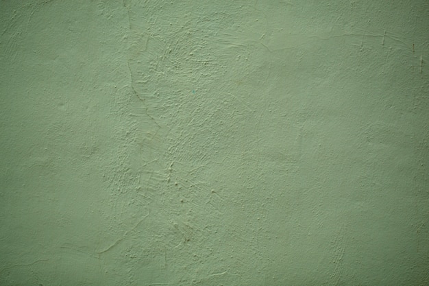 Textura de parede verde floresta de estilo vintage em uma parede pintada com acabamento áspero em close up