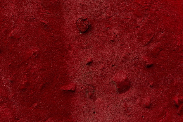 Textura de parede vermelha Concreto vermelho de textura áspera A superfície é pintada com um spray aerossol