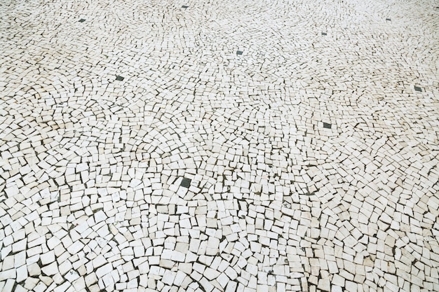 Textura de passagem do pavimento de pedra de superfície pavimentada estrada velha rua. Pavimento de paralelepípedos de granito