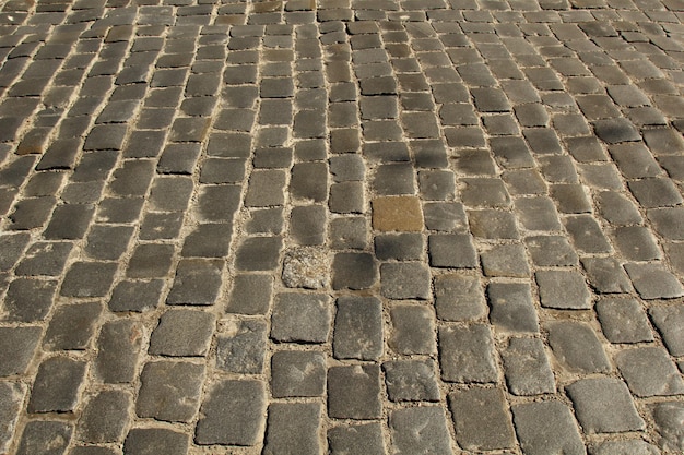 Textura de pavimento de pedra Fundo de pavimento de paralelepípedos de granito Fundo abstrato do antigo pavimento de paralelepípedos Textura perfeita