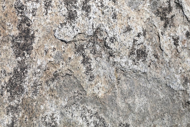 Textura de pedra áspera. Detalhe da fachada de pedra de uma casa. Material duro e áspero