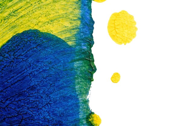 Foto textura de pintura acrílica abstrata azul-verde-amarelo em fundo branco usando o método de mancha de tinta