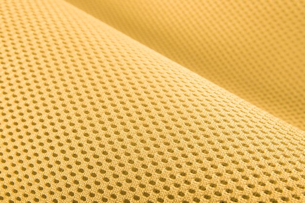 Textura de tecido amarelo áspero tecido de tricô de algodão materiais modernos de controle de temperatura flexíveis impermeáveis têxteis inteligentes multifuncionais close-up foco seletivo não rasga