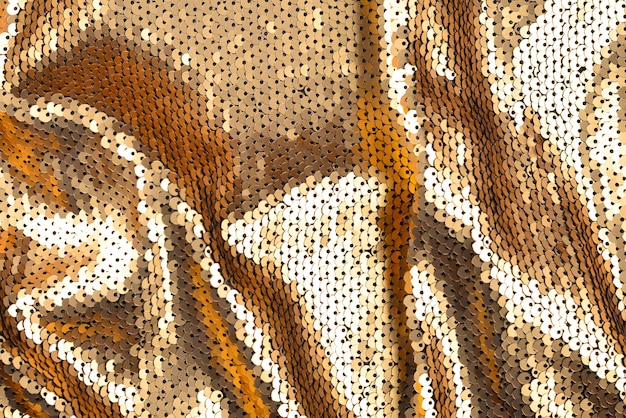 Textura de tecido de lantejoulas douradas.