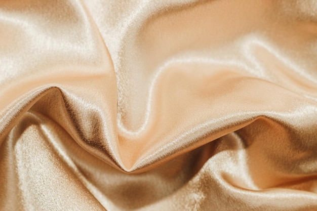 Textura de tecido de seda dourada Fundo de moda cetim para conteúdo
