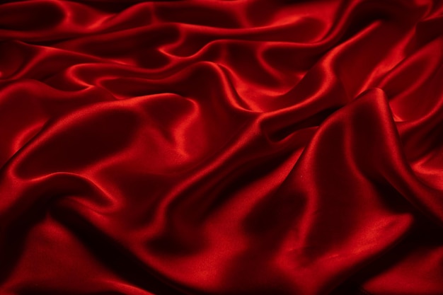 Textura de tecido de seda vermelha ou cetim luxuoso pode ser usada como fundo abstrato