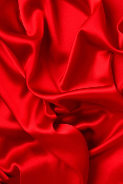 Textura de tecido de seda vermelha ou cetim luxuoso pode ser usada como superfície abstrata. Vista do topo