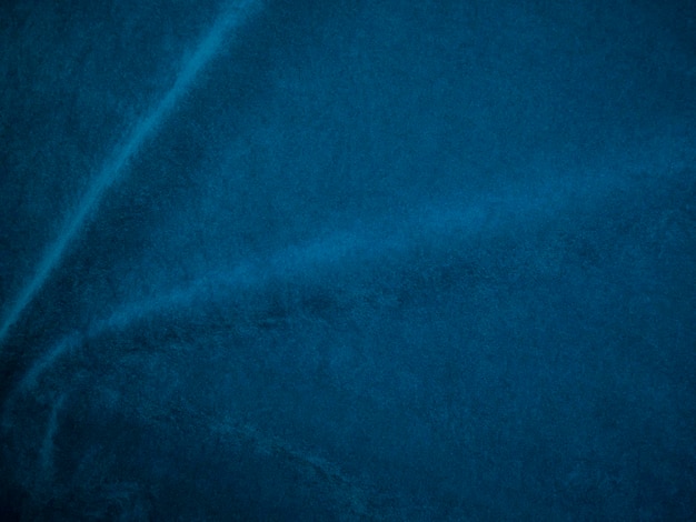 Foto textura de tecido de veludo azul usada como pano de fundo fundo de tecido azul de material têxtil macio e liso há espaço para texto