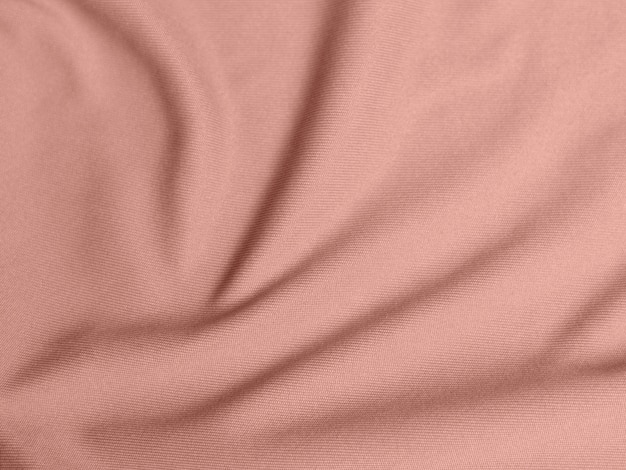 Textura de tecido de veludo cor de ouro rosa usada como fundo fundo de tecido de ouro rosa vazio de material têxtil macio e liso há espaço para texto