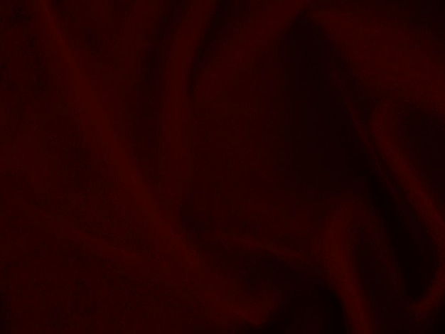 Textura de tecido de veludo vermelho escuro usado como fundo Fundo de tecido vermelho escuro vazio de material têxtil macio e liso Há espaço para texto