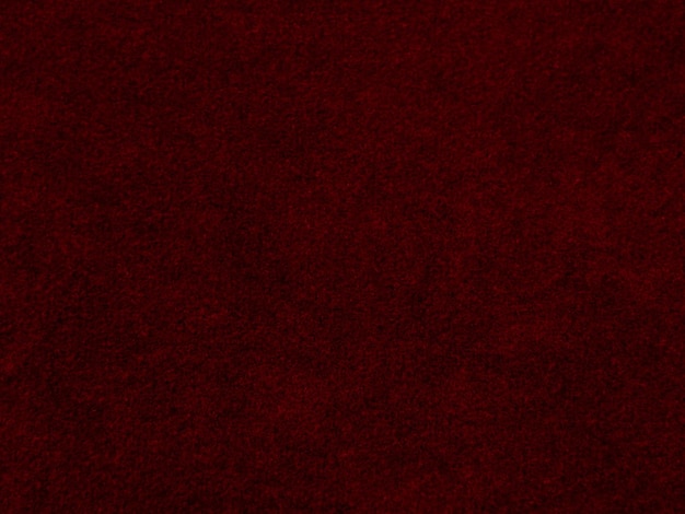 Textura de tecido de veludo vermelho usada como fundo fundo de tecido vermelho vazio de material têxtil macio e liso há espaço para texto