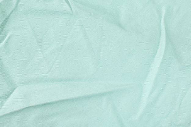 Foto textura de tecido é fundo de cor azul, dobras onduladas de pano