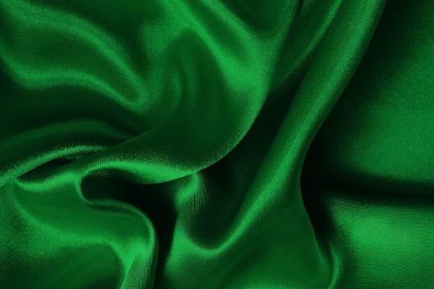 Foto textura de tecido verde escuro para fundo e desenho de obras de arte bonito padrão amassado de seda ou linho