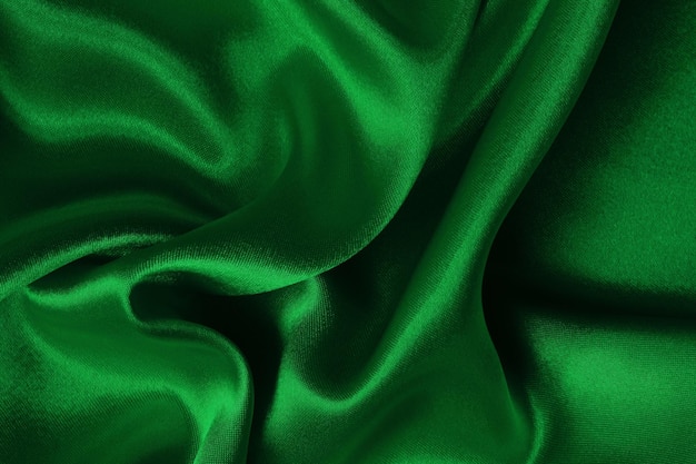 Textura de tecido verde escuro para fundo e desenho de obras de arte bonito padrão amassado de seda ou linho