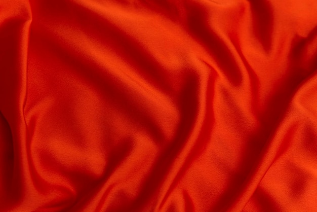 Textura de tecido vermelho fechado Têxtil como fundo abstrato Material de seda ou cetim Pano brilhante simples