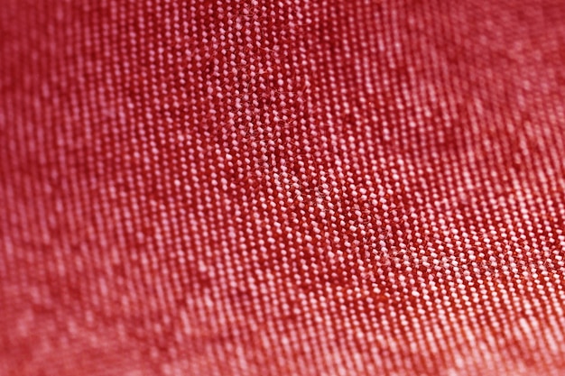 Textura de tecido vermelho têxtil close-up, foco em apenas um ponto, fundo desfocado suave