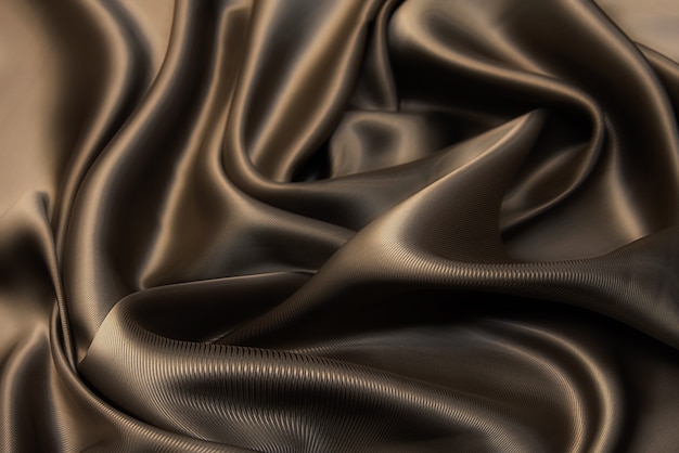 Foto textura de tecido viscose marrom. plano de fundo, padrão.