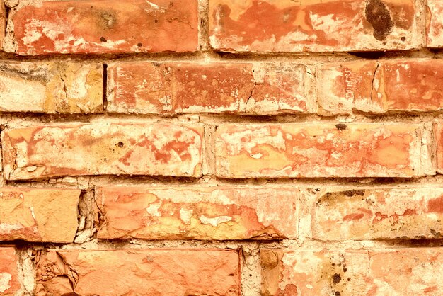 Foto textura de tijolos com arranhões e rachaduras