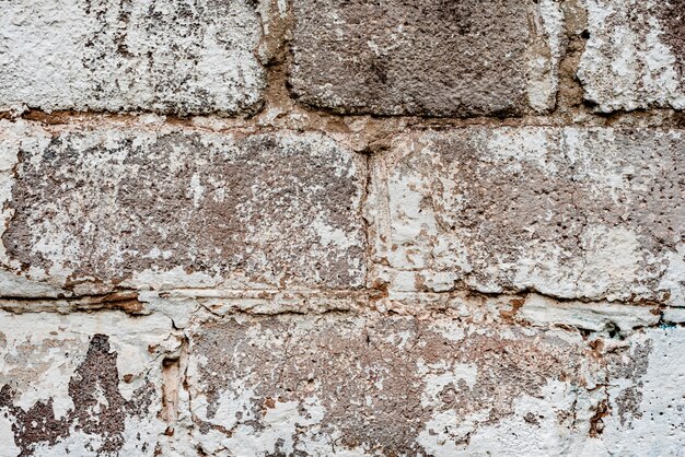 Foto textura de tijolos com arranhões e rachaduras